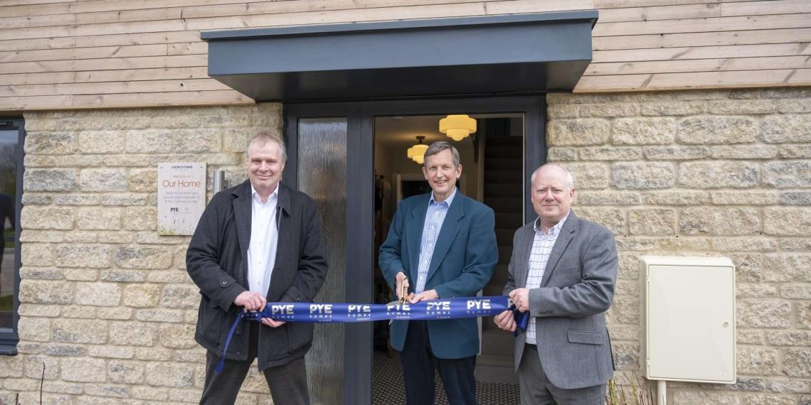 Three men cutting a Pye Homes ribbon to open the customer lounge